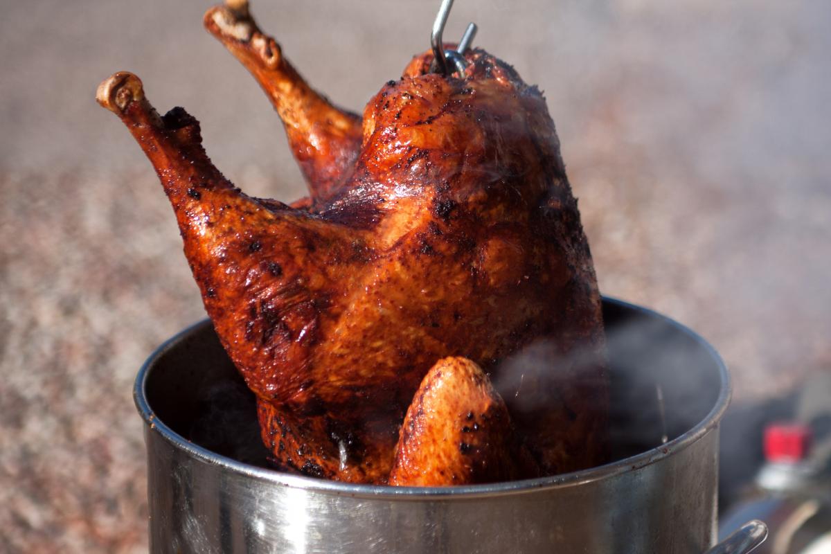 Cooked turkey gets pulled out of pot after frying